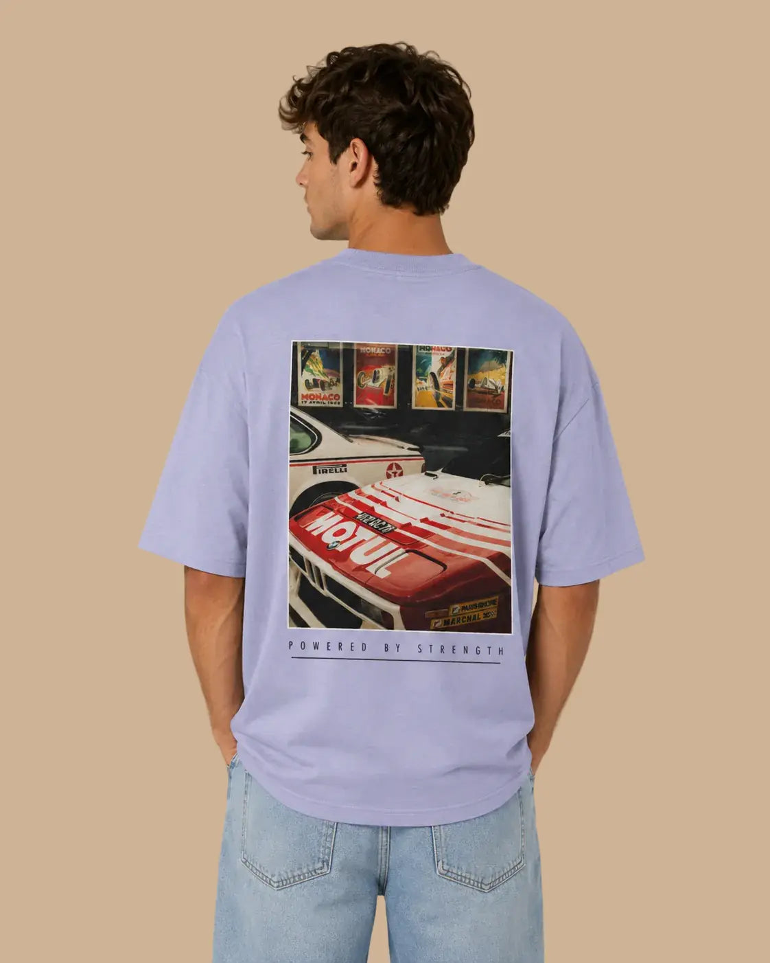 Male model wearing the Legacy Racing Division violet oversized T-shirt, back view
