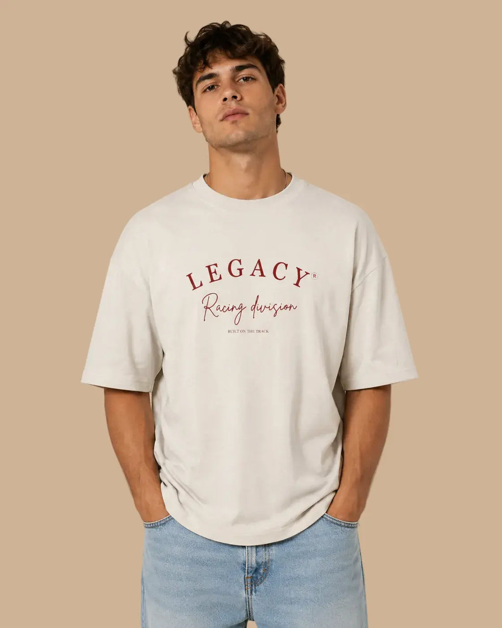 Male model wearing the Legacy Racing Division Natural Raw oversized T-shirt, front view