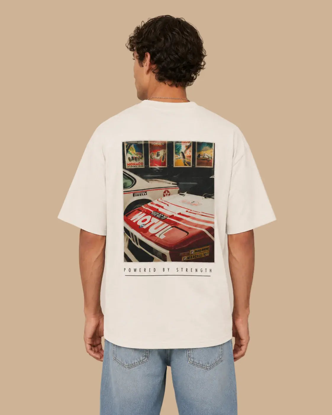Male model wearing the Legacy Racing Division Natural Raw oversized T-shirt, back view